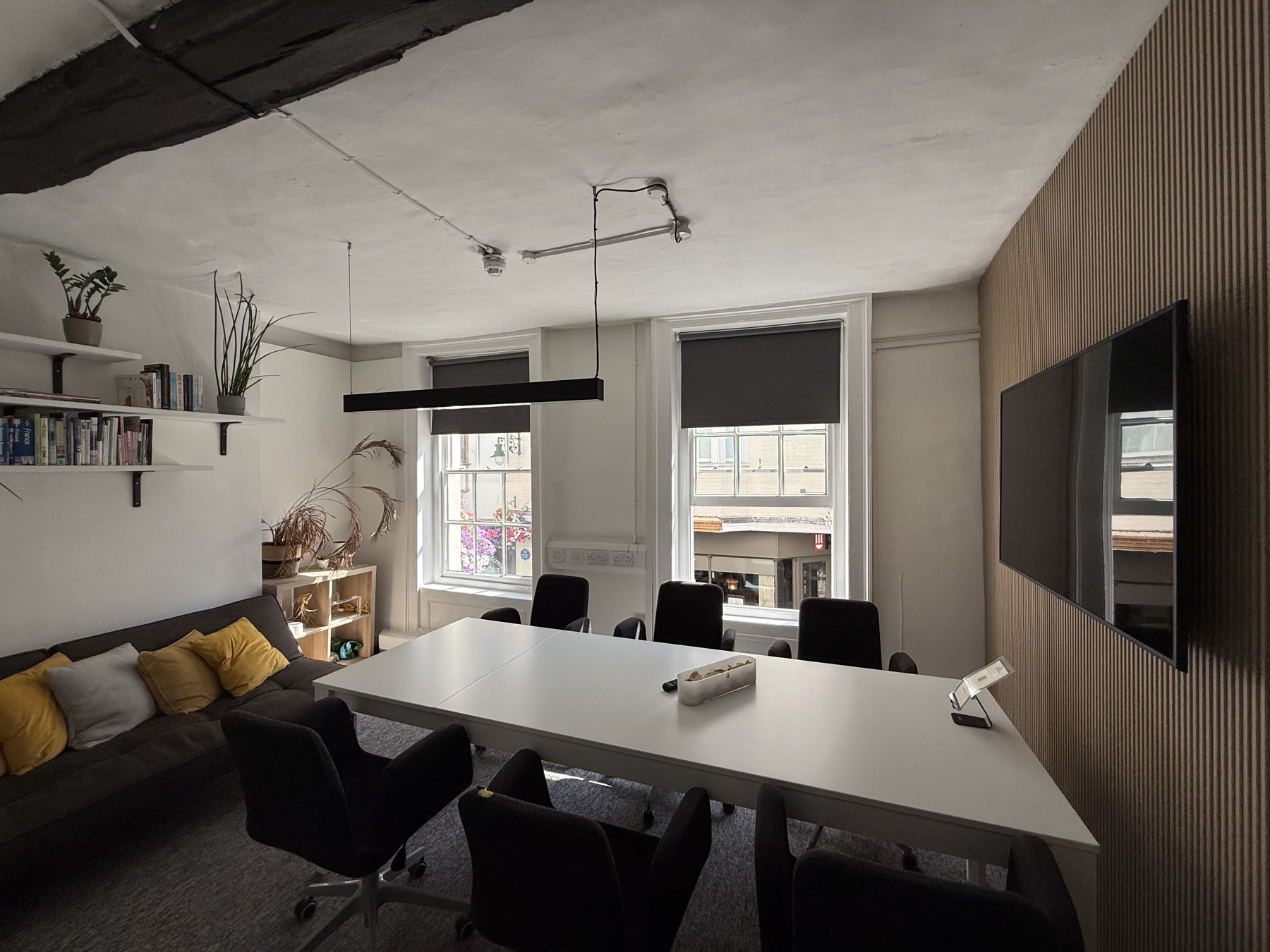 The Knight’s Tale — a bright, empty meeting room at The Quarter, sunlight pouring across the table