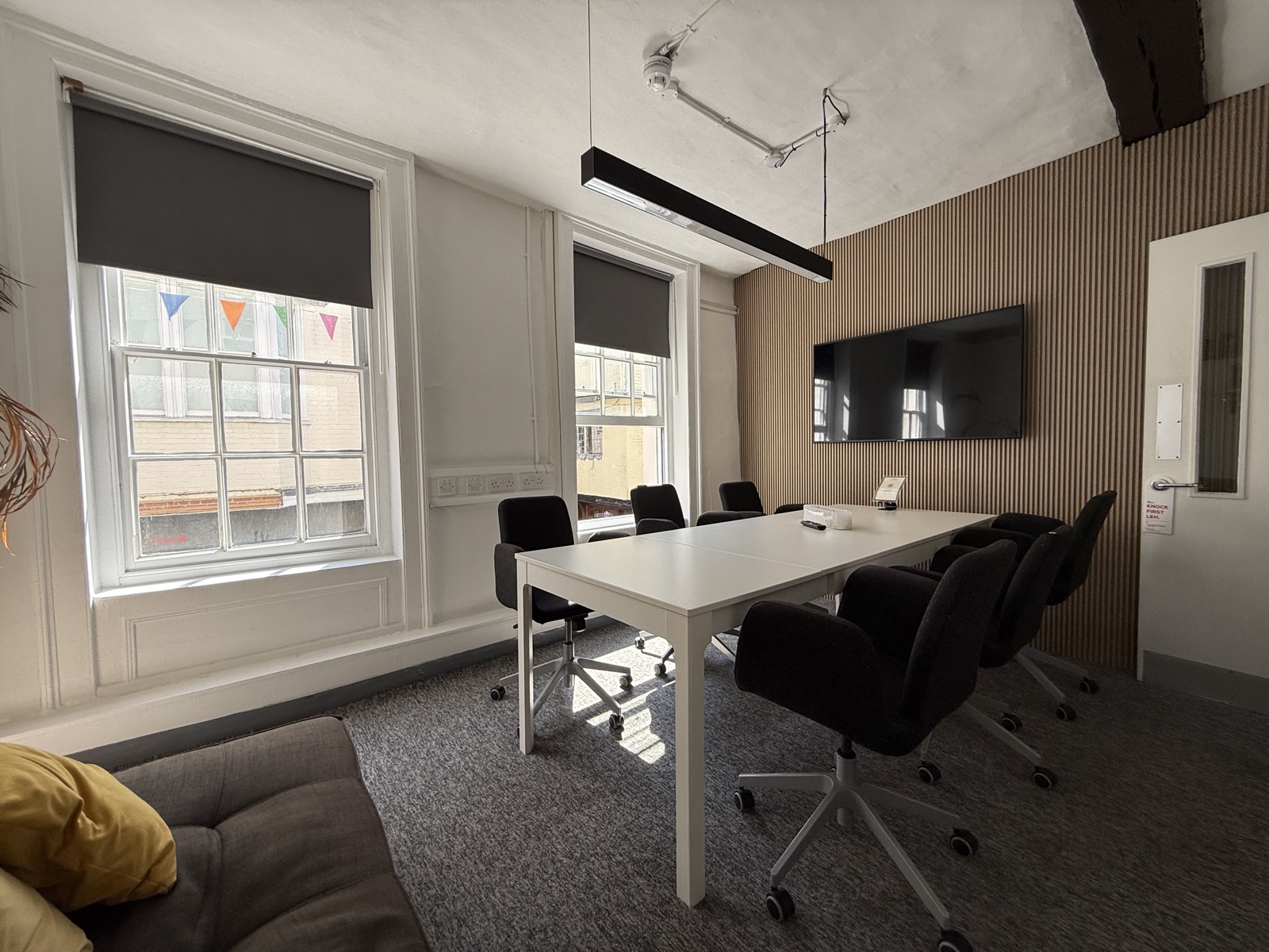 The Knight’s Tale — a sunlit boardroom with plug-and-play A/V and a slat wall